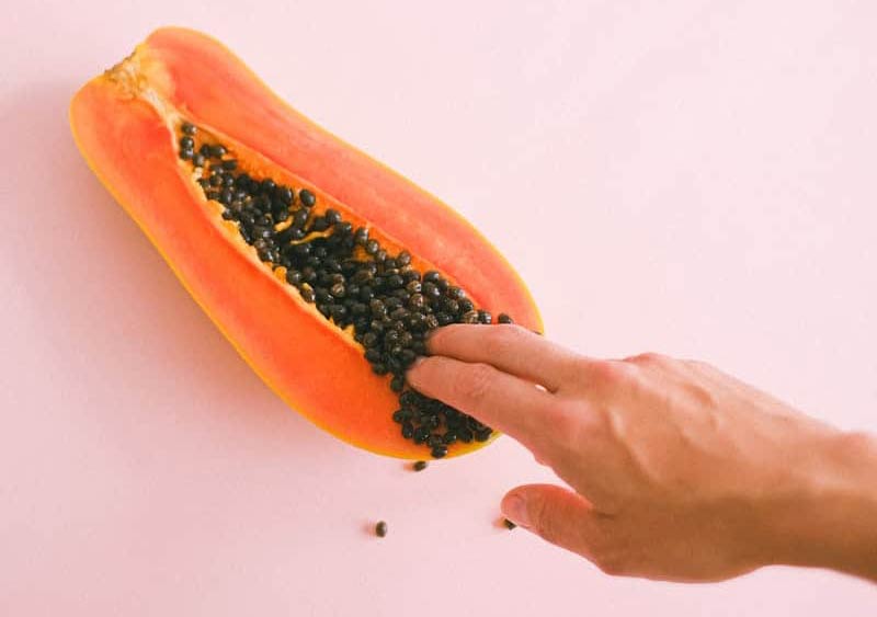 Fingers touching fruit resembling vagina(Yoni)