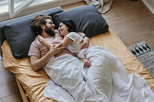 Happy couple discussing using Orajel to desensitize penis