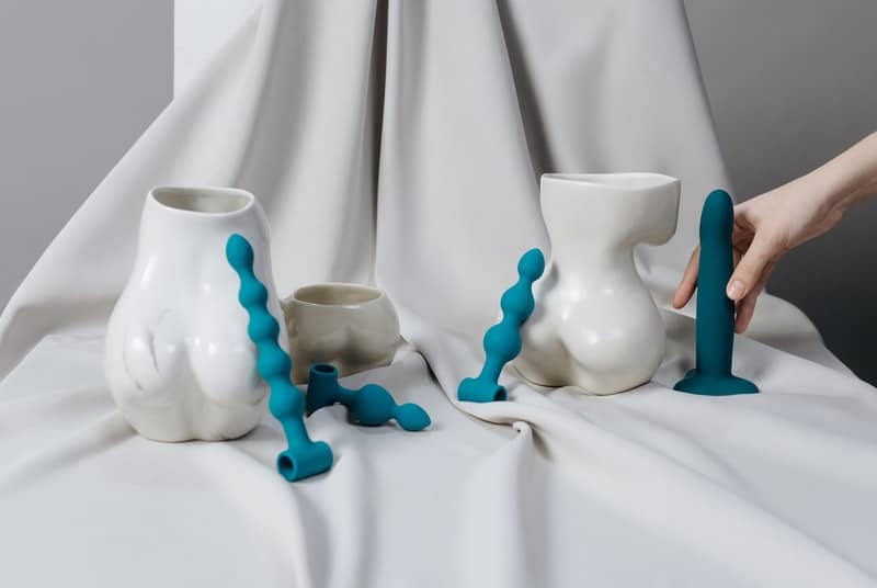 butt shaped white vases with male-g-spot toys placed around them