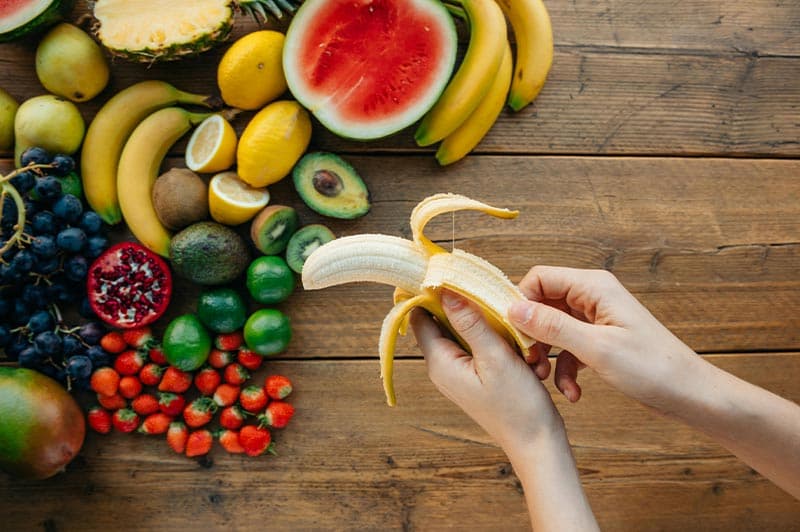 man holding banana simulating ejaculation