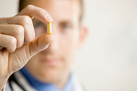 Doctor holding up a premature ejaculation pill