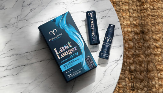 bottle of delay spray and product box laying face up on a marble table top